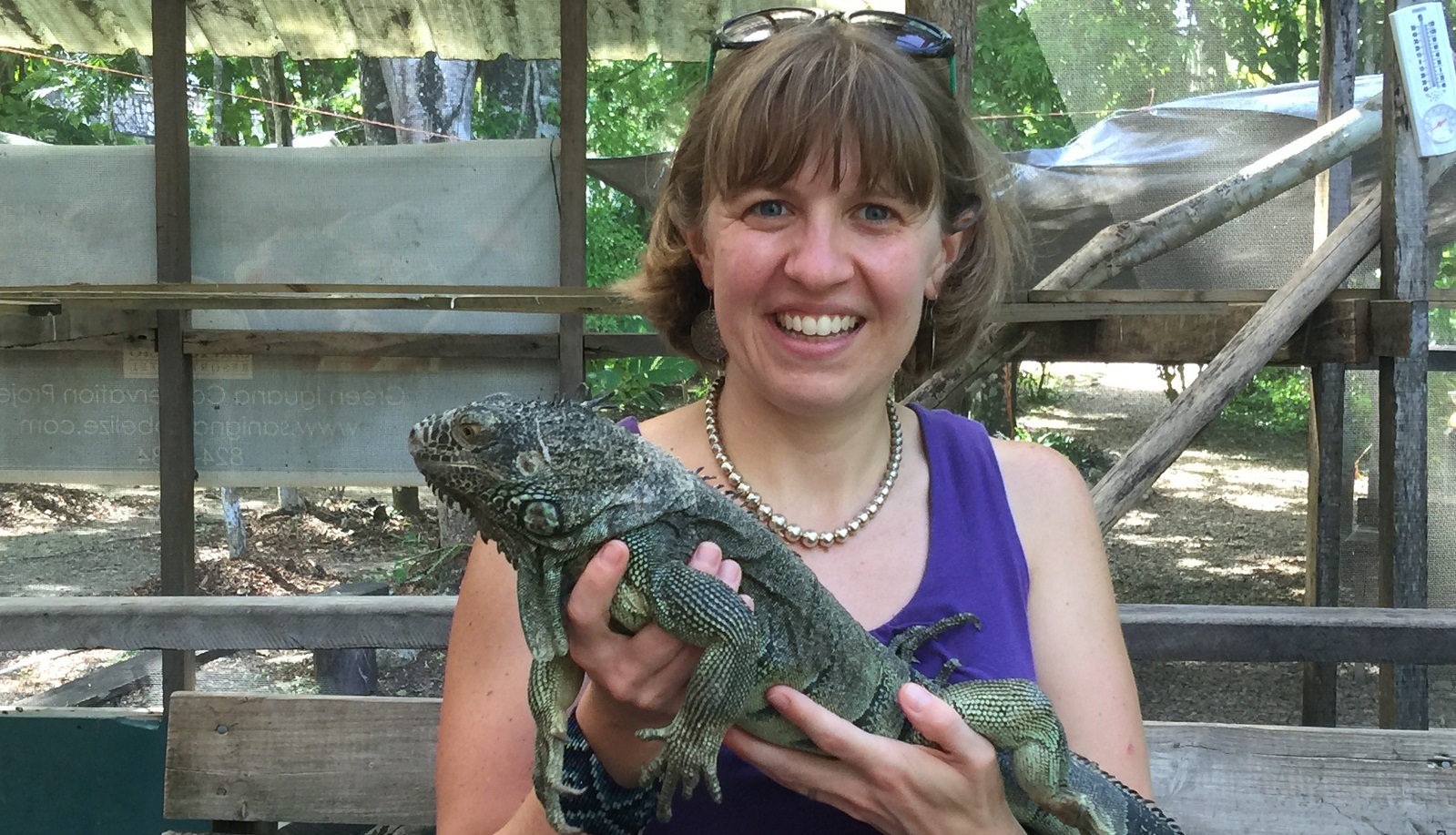 Photo of Alicia McGill holding an Iguana